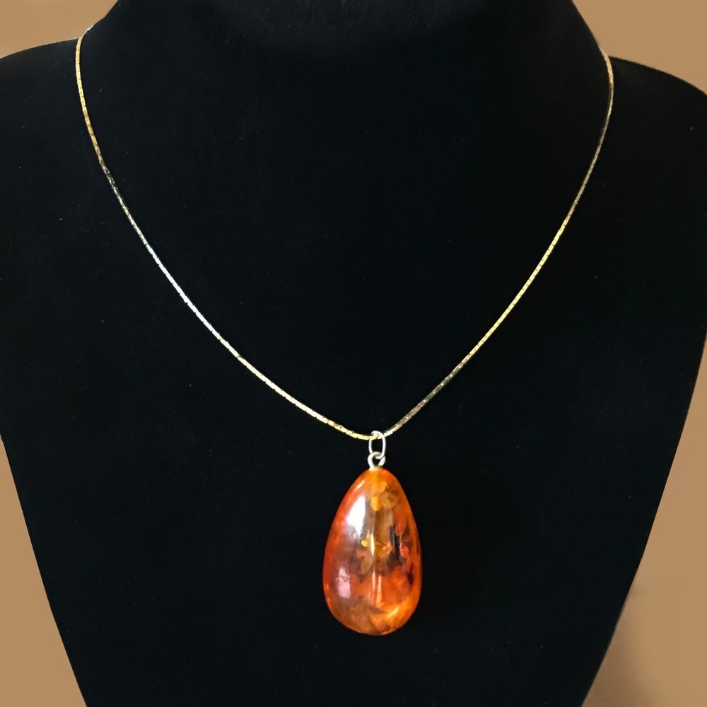 Large amber pendant on gold tone snake chain
